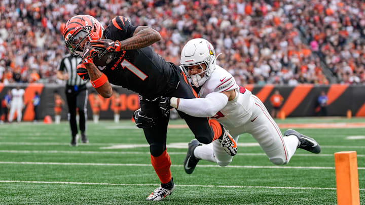 Cincinnati Bengals wide receiver Ja'Marr Chase (1) breaks a tackle from Arizona Cardinals linebacker Cody Simon (50) as he dives into the end zone for a touchdown in the first quarter of the NFL Week 17 game between the Cincinnati Bengals and the Arizona Cardinals at Paycor Stadium in Downtown Cincinnati on Sunday, Dec. 28, 2025. The Bengals led 23-7 at halftime.