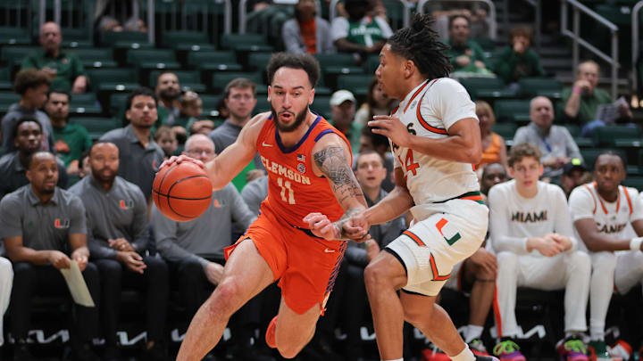 Dec 7, 2024; Coral Gables, Florida, USA; Clemson Tigers guard Jaeden Zackery (11) drives to the basket past Miami Hurricanes guard Nijel Pack (24) during the first half at Watsco Center. Dec 7, 2024; Coral Gables, Florida, USA; Clemson Tigers guard Jaeden Zackery (11) drives to the basket past Miami Hurricanes guard Nijel Pack (24) during the first half at Watsco Center.