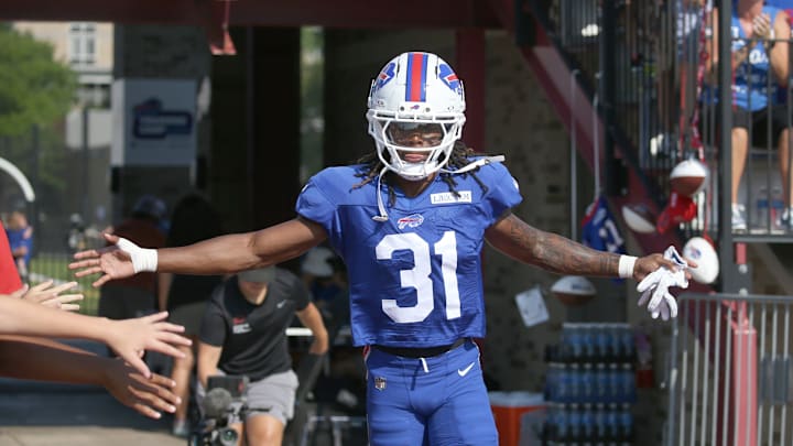 Bills rookie defensive back Maxwell Hairston high-fives fans as he runs onto the field during Buffalo Bills training camp