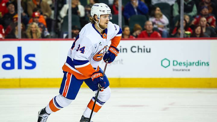 Jan 17, 2026; Calgary, Alberta, CAN; New York Islanders defenseman Adam Boqvist (34) controls the puck against the Calgary Flames during the second period at Scotiabank Saddledome. Mandatory Credit: Sergei Belski-Imagn Images