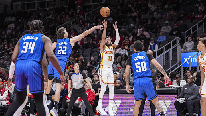 Feb 20, 2025; Atlanta, Georgia, USA; Atlanta Hawks guard Trae Young (11) shoots from the outside over Orlando Magic forward Franz Wagner (22) during the second half at State Farm Arena. Mandatory Credit: Dale Zanine-Imagn Images
