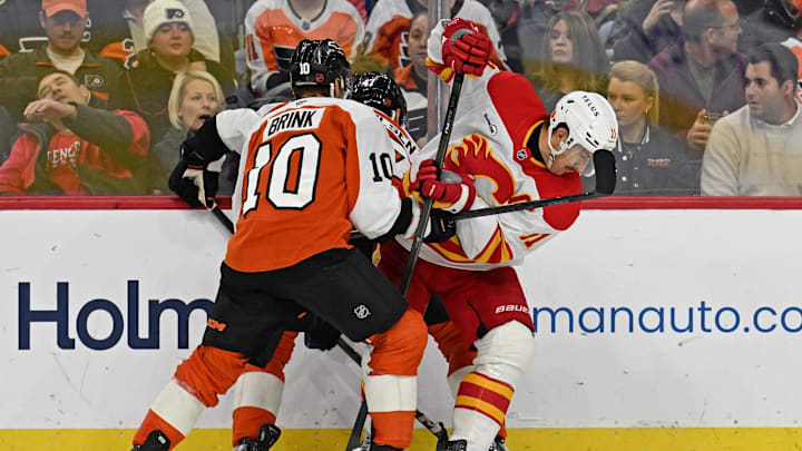 Nov 2, 2025; Philadelphia, Pennsylvania, USA; Calgary Flames center Mikael Backlund (11) battle for the puck with Philadelphia Flyers right wing Bobby Brink (10) during the third period at Xfinity Mobile Arena. Mandatory Credit: Eric Hartline-Imagn Images Nov 2, 2025; Philadelphia, Pennsylvania, USA; Calgary Flames center Mikael Backlund (11) battle for the puck with Philadelphia Flyers right wing Bobby Brink (10) during the third period at Xfinity Mobile Arena. Mandatory Credit: Eric Hartline-Imagn Images