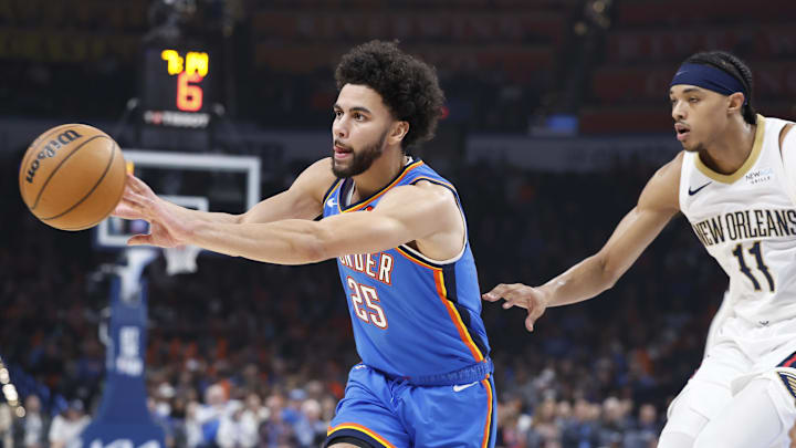 Nov 13, 2024; Oklahoma City, Oklahoma, USA; Oklahoma City Thunder guard Ajay Mitchell (25) passes in front of New Orleans Pelicans guard Brandon Boston Jr. (11) during the first quarter at Paycom Center. Mandatory Credit: Alonzo Adams-Imagn Images