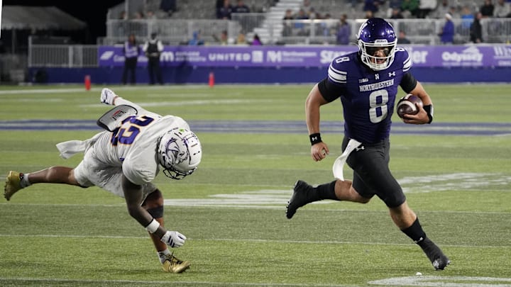 Sep 5, 2025; Evanston, Illinois, USA; Western Illinois Leathernecks defensive back Malini Ti'a (33) defends Northwestern Wildcats quarterback Preston Stone (8) during the second half at Northwestern Medicine Field at Martin Stadium. Mandatory Credit: David Banks-Imagn Images