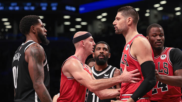 Nov 1, 2022; Brooklyn, New York, USA; Chicago Bulls center Nikola Vucevic (9) argues with Brooklyn Nets forward Royce O'Neale (00) while being restrained by guard Alex Caruso (6) during the second half at Barclays Center. Mandatory Credit: Vincent Carchietta-USA TODAY Sports