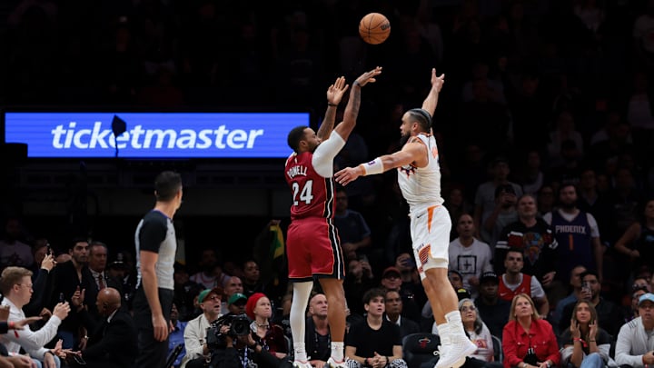 Jan 13, 2026; Miami, Florida, USA; Miami Heat guard Norman Powell (24) shoots the basketball over Phoenix Suns forward Dillon Brooks (3) during the fourth quarter at Kaseya Center. Mandatory Credit: Sam Navarro-Imagn Images