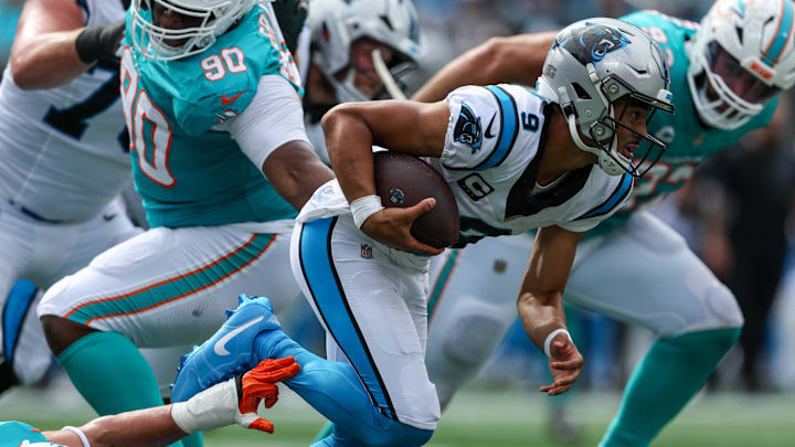 Oct 5, 2025; Charlotte, North Carolina, USA; Carolina Panthers quarterback Bryce Young (9) breaks free of a tackle during the third quarter against the Miami Dolphins at Bank of America Stadium. Mandatory Credit: Cory Knowlton-Imagn Images