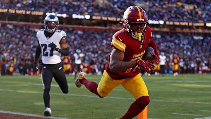 Dec 22, 2024; Landover, Maryland, USA; Washington Commanders wide receiver Terry McLaurin (17) catches a touchdown  pass against Philadelphia Eagles cornerback Quinyon Mitchell (27) during the second quarter at Northwest Stadium. 