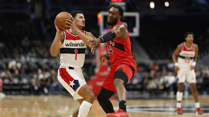 Oct 11, 2024; Washington, District of Columbia, USA; Washington Wizards guard Johnny Davis (1) holds the ball as Toronto Raptors center Bruno Fernando (24) defends in the second quarter at Capital One Arena. Mandatory Credit: Geoff Burke-Imagn Images