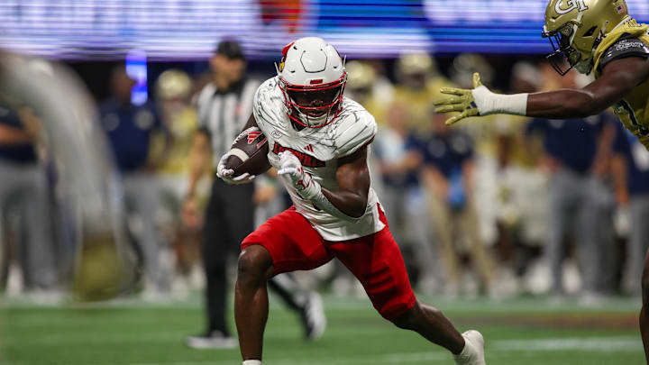 Sep 1, 2023; Atlanta, Georgia, USA; Louisville Cardinals running back Maurice Turner (4) runs the ball against the Georgia Tech Yellow Jackets in the second half at Mercedes-Benz Stadium. Mandatory Credit: Brett Davis-Imagn Images Sep 1, 2023; Atlanta, Georgia, USA; Louisville Cardinals running back Maurice Turner (4) runs the ball against the Georgia Tech Yellow Jackets in the second half at Mercedes-Benz Stadium. Mandatory Credit: Brett Davis-Imagn Images