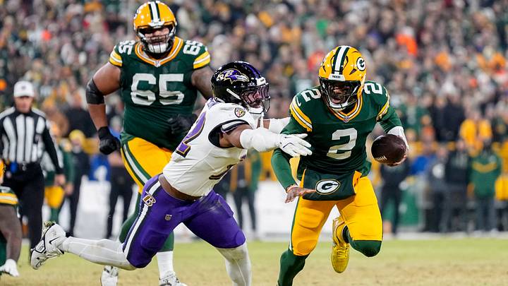 Dec 27, 2025; Green Bay, Wisconsin, USA; Baltimore Ravens linebacker Trenton Simpson (32) tackles Green Bay Packers quarterback Malik Willis (2) during the third quarter at Lambeau Field. Mandatory Credit: Jeff Hanisch-Imagn Images