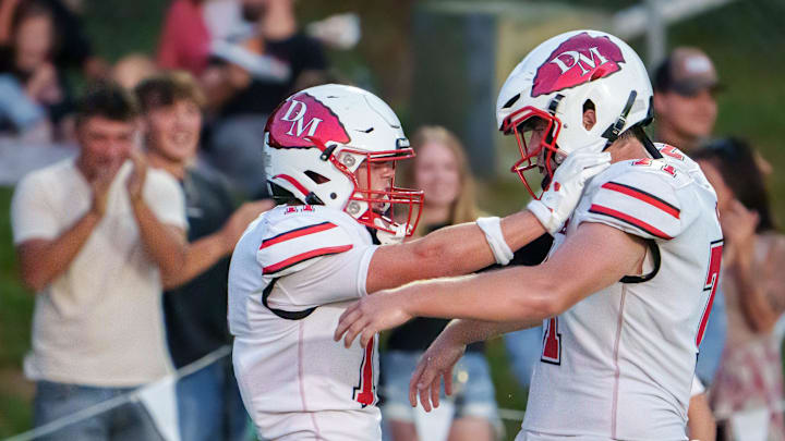 Dee-Mack’s Parker Eggenberger, left, and Vinnie Peek celebrate Eggenberger’s touchdown reception against Eureka in the first half of their high school football opener Friday, Aug. 29, 2025 at Eureka High School. The Chiefs routed the Hornets 38-8.