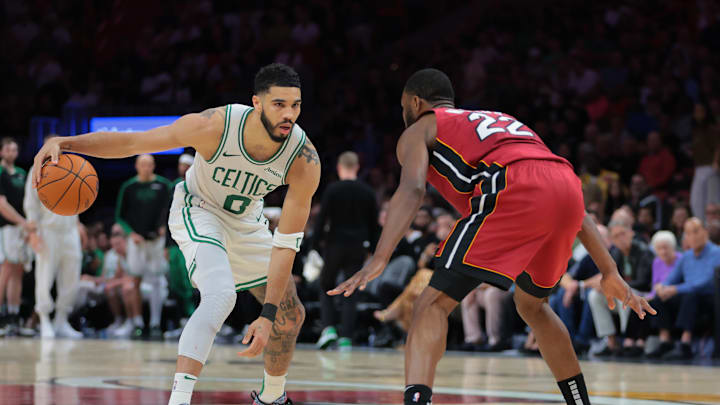 Mar 14, 2025; Miami, Florida, USA; Boston Celtics forward Jayson Tatum (0) dribbles the basketball as Miami Heat forward Andrew Wiggins (22) defends during the fourth quarter at Kaseya Center. Mandatory Credit: Sam Navarro-Imagn Images Mar 14, 2025; Miami, Florida, USA; Boston Celtics forward Jayson Tatum (0) dribbles the basketball as Miami Heat forward Andrew Wiggins (22) defends during the fourth quarter at Kaseya Center. Mandatory Credit: Sam Navarro-Imagn Images