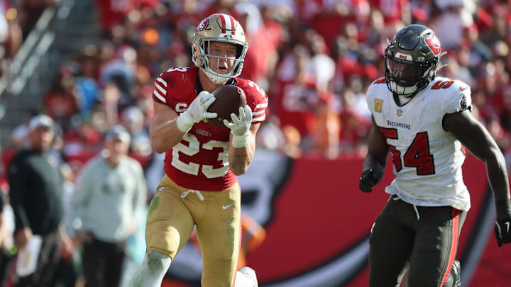 Nov 10, 2024; Tampa, Florida, USA; San Francisco 49ers running back Christian McCaffrey (23) catches the ball over Tampa Bay Buccaneers linebacker Lavonte David (54) during the second half at Raymond James Stadium. Mandatory Credit: Kim Klement Neitzel-Imagn Images