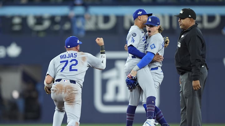 Oct 31, 2025; Toronto, Ontario, CAN; Los Angeles Dodgers second baseman Miguel Rojas (72) and shortstop Mookie Betts (50) and first baseman Enrique Hernandez (8) celebrate after defeating the Toronto Blue Jays during game six of the 2025 MLB World Series at Rogers Centre. Mandatory Credit: John E. Sokolowski-Imagn Images Oct 31, 2025; Toronto, Ontario, CAN; Los Angeles Dodgers second baseman Miguel Rojas (72) and shortstop Mookie Betts (50) and first baseman Enrique Hernandez (8) celebrate after defeating the Toronto Blue Jays during game six of the 2025 MLB World Series at Rogers Centre. Mandatory Credit: John E. Sokolowski-Imagn Images