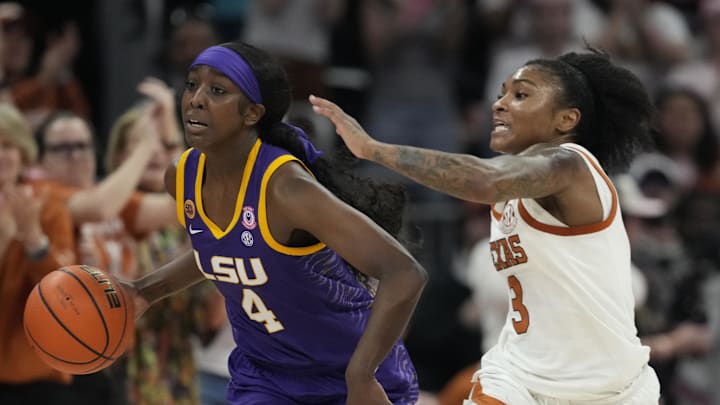 Feb 16, 2025; Austin, Texas, USA; Louisiana State Lady Tigers guard Flau'jae Johnson (4) dribbles up court while defended by Texas Longhorns guard Rori Harmon (3) during the second half at Moody Center. Mandatory Credit: Scott Wachter-Imagn Images