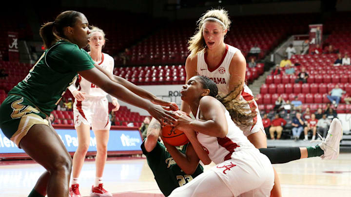 Alabama guard Jessica Timmons (23) fights for a ball on the floor by South Florida forward Daniela Gonzalez (20) and South Florida forward Romi Levy (23) Thursday, Nov. 16, 2023, at Coleman Coliseum.