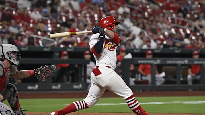 Sep 15, 2025; St. Louis, Missouri, USA; St. Louis Cardinals second baseman Brendan Donovan (21) hits a single against the Cincinnati Reds in the sixth inning at Busch Stadium. Mandatory Credit: Joe Puetz-Imagn Images