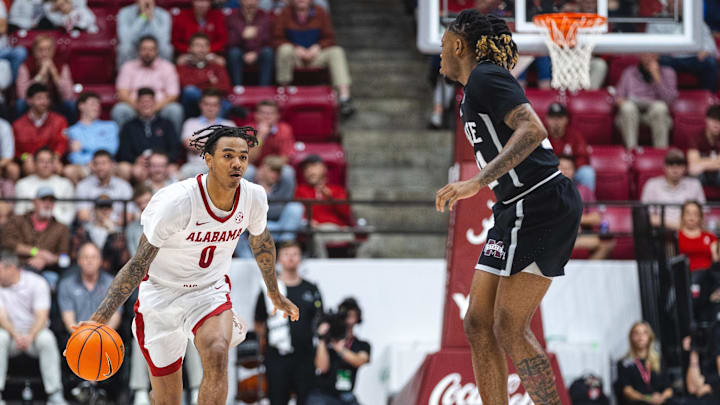 Feb 25, 2025; Tuscaloosa, Alabama, USA; Alabama Crimson Tide guard Labaron Philon (0) drives against Mississippi State Bulldogs guard Martavious Russell (21) during the second half at Coleman Coliseum. Mandatory Credit: Will McLelland-Imagn Images