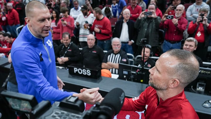 Kentucky's Mark Pope and Louisville's Pat Kelsey greet each other before the Wildcats-Cardinals rivalry game in Louisville, Kentucky. Nov. 12, 2025