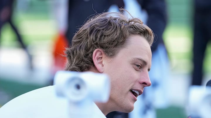 Injured Cincinnati Bengals quarterback Joe Burrow (9) talks on the bench with injured defensive end Trey Hendrickson (91) in the second quarter of the NFL Week 12 game between the Cincinnati Bengals and the New England Patriots at Paycor Stadium in downtown Cincinnati on Sunday, Nov. 23, 2025.