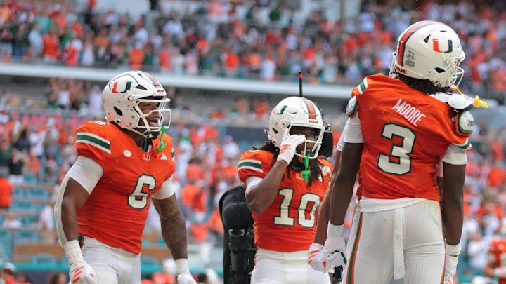 Sep 13, 2025; Miami Gardens, Florida, USA; Miami Hurricanes wide receiver Joshua Moore (3) celebrates with running back CharMar Brown (6) and wide receiver Malachi Toney (10) after scoring a touchdown against the South Florida Bulls during the first quarter at Hard Rock Stadium. Mandatory Credit: Sam Navarro-Imagn Images Sep 13, 2025; Miami Gardens, Florida, USA; Miami Hurricanes wide receiver Joshua Moore (3) celebrates with running back CharMar Brown (6) and wide receiver Malachi Toney (10) after scoring a touchdown against the South Florida Bulls during the first quarter at Hard Rock Stadium. Mandatory Credit: Sam Navarro-Imagn Images