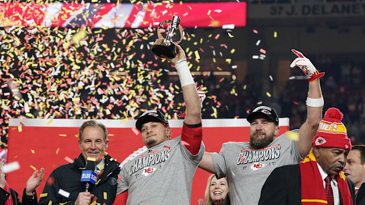 Jan 26, 2025; Kansas City, MO, USA; Kansas City Chiefs quarterback Patrick Mahomes (15) and tight end Travis Kelce (87) react after holding the  Lamar Hunt Trophy after the AFC Championship game against the Buffalo Bills at GEHA Field at Arrowhead Stadium. Mandatory Credit: Denny Medley-Imagn Images