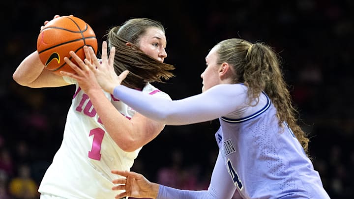 Iowa guard Taylor Stremlow (1) looks to pass the the basketball against Washington guard Elle Ladine (24) Feb. 11, 2026 at Carver-Hawkeye Arena in Iowa City, Iowa. Iowa guard Taylor Stremlow (1) looks to pass the the basketball against Washington guard Elle Ladine (24) Feb. 11, 2026 at Carver-Hawkeye Arena in Iowa City, Iowa.