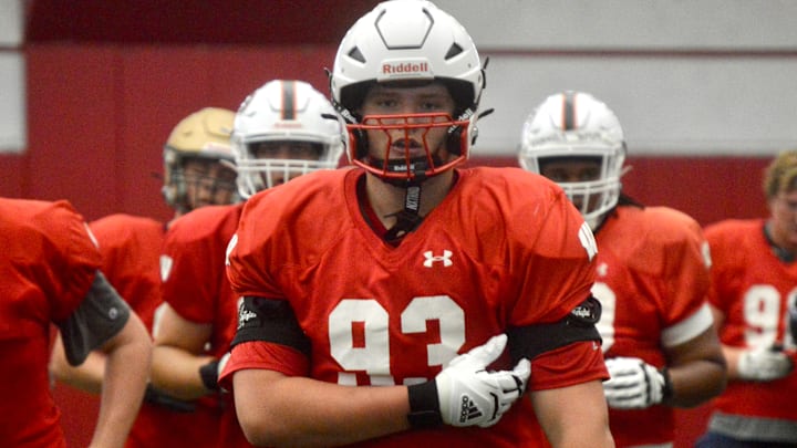 2027 in-state offensive lineman Reece Mallinger (Sussex Hamilton) jogs off the field after a drill during Wisconsin's football camp on June 15.