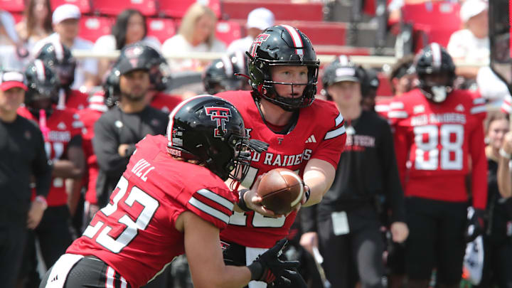 Sep 6, 2025; Lubbock, Texas, USA; Texas Tech Red Raiders quarterback Will Hammonds (15) hands off to running back Adam Hill (23) in the second half against the Kent State Golden Flashes at Jones AT&T Stadium. Mandatory Credit: Michael C. Johnson-Imagn Images