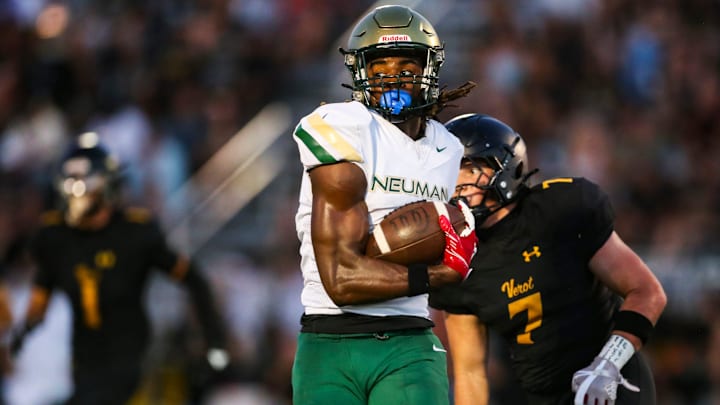 Neumann Celtics receiver Jayden Petit runs after making a catch.