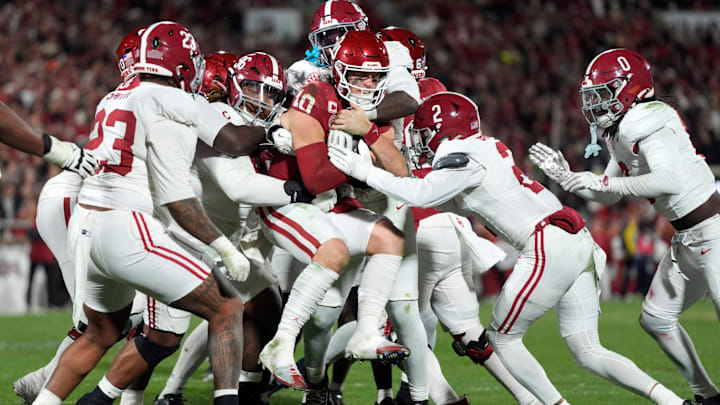 Oklahoma Sooners quarterback John Mateer (10) is brought down by a group of Alabama defenders during a first-round College Football Playoff game between the University of Oklahoma Sooners (OU) and the Alabama Crimson Tide at Gaylord Family – Oklahoma Memorial Stadium in Norman, Okla., Friday, Dec. 19, 2025. Alabama won 34-24.
