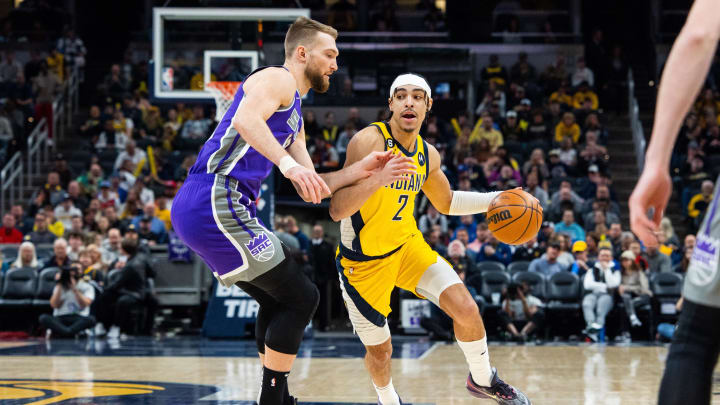 Feb 3, 2023; Indianapolis, Indiana, USA; Indiana Pacers guard Andrew Nembhard (2) dribbles the ball while Sacramento Kings forward Domantas Sabonis (10)  defends in the first quarter at Gainbridge Fieldhouse. Mandatory Credit: Trevor Ruszkowski-USA TODAY Sports