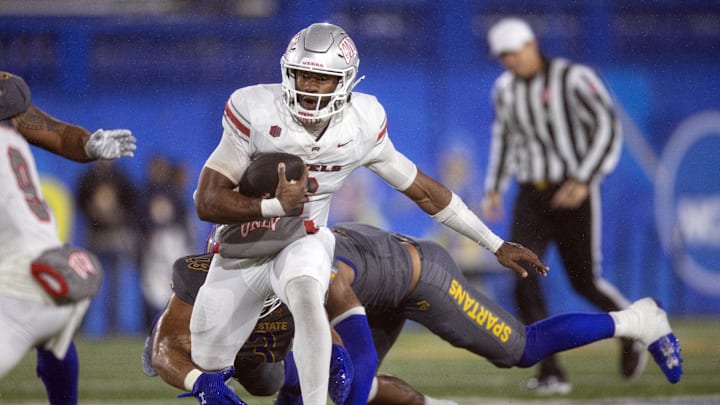 Nov 22, 2024; San Jose, California, USA; UNLV Rebels quarterback Hajj-Malik Williams (6) scrambles away from defensive pressure by the San Jose State Spartans during the fourth quarter at CEFCU Stadium. Mandatory Credit: D. Ross Cameron-Imagn Images