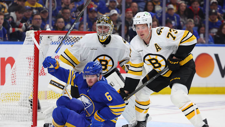 Apr 19, 2026; Buffalo, New York, USA; Boston Bruins defenseman Charlie McAvoy (73) knocks down Buffalo Sabres left wing Zach Benson (6) in front of the net as Boston Bruins goaltender Jeremy Swayman (1) watches the puck during the second period in game one of the first round of the 2026 Stanley Cup Playoffs at KeyBank Center. Mandatory Credit: Timothy T. Ludwig-Imagn Images