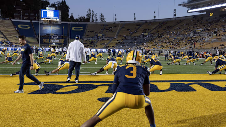 Cal quarterback Jaron-Keawe Sagapolutele (3) stretches with his teammates before the Duke game
