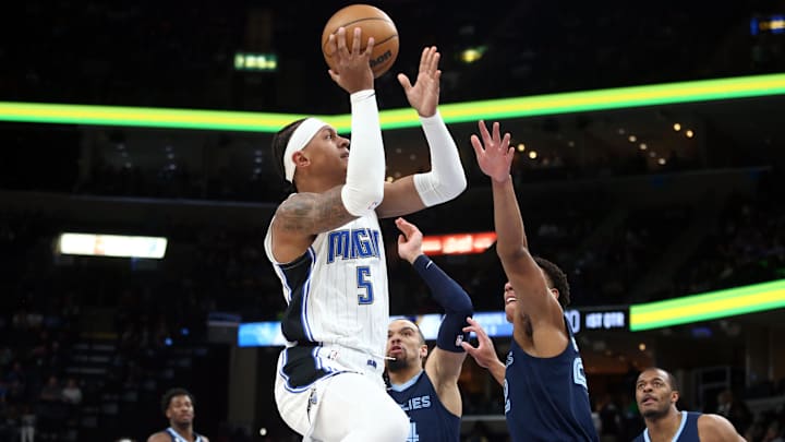 Mar 28, 2023; Memphis, Tennessee, USA; Orlando Magic forward Paolo Banchero (5) shoots as Memphis Grizzlies guard Desmond Bane (22) defends during the first half at FedExForum. Mandatory Credit: Petre Thomas-Imagn Images