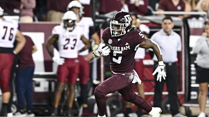 Nov 16, 2024; College Station, Texas, USA; Texas A&M Aggies running back Amari Daniels (5) runs the ball during the first half against the New Mexico State Aggies at Kyle Field. Mandatory Credit: Maria Lysaker-Imagn Images 