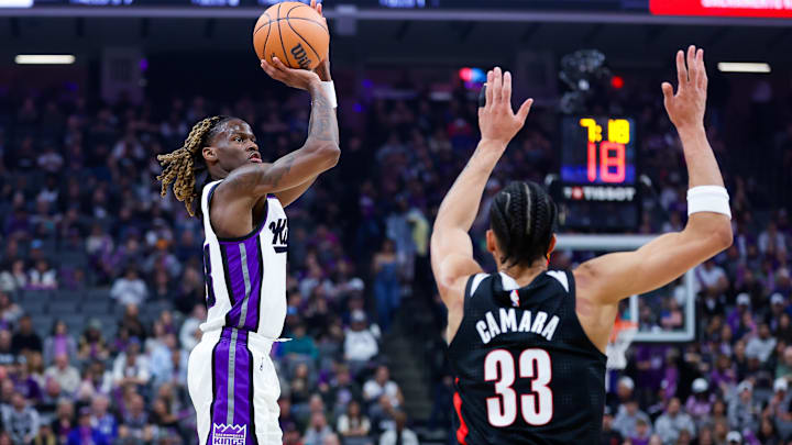 Mar 17, 2025; Sacramento, California, USA; Sacramento Kings guard Keon Ellis (23) shoots against Portland Trail Blazers forward Toumani Camara (33) during the first quarter at Golden 1 Center. Mandatory Credit: Sergio Estrada-Imagn Images