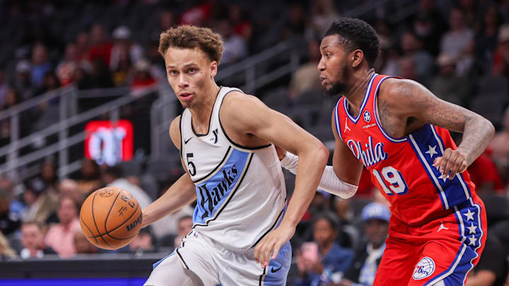 Mar 23, 2025; Atlanta, Georgia, USA; Atlanta Hawks guard Dyson Daniels (5) drives past Philadelphia 76ers forward Justin Edwards (19) in the fourth quarter at State Farm Arena. Mandatory Credit: Brett Davis-Imagn Images
