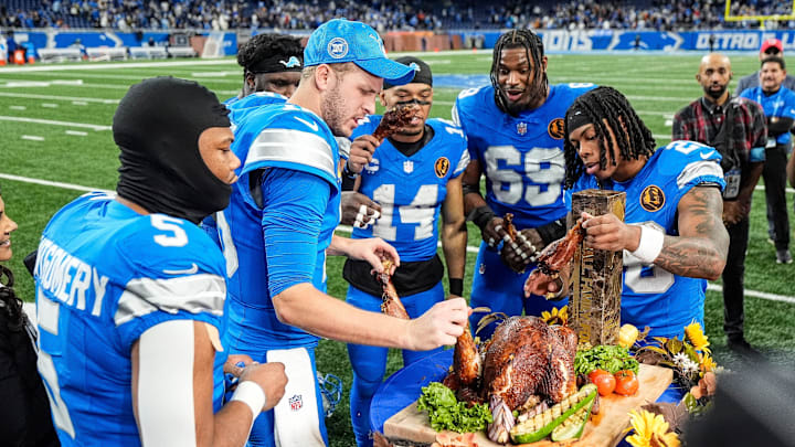Detroit Lions running back David Montgomery (5), quarterback Jared Goff (16), defensive tackle DJ Reader (98), wide receiver Amon-Ra St. Brown (14), linebacker Al-Quadin Muhammad (69) and running back Jahmyr Gibbs (26).