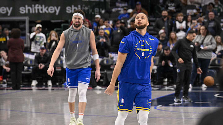 Feb 12, 2025; Dallas, Texas, USA; Dallas Mavericks guard Klay Thompson (left) and Golden State Warriors guard Stephen Curry (right) warm up before the game at the American Airlines Center. Mandatory Credit: Jerome Miron-Imagn Images