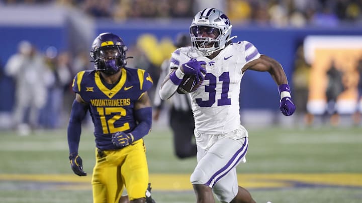 Oct 19, 2024; Morgantown, West Virginia, USA; Kansas State Wildcats running back DJ Giddens (31) runs after a catch during the third quarter against the West Virginia Mountaineers at Mountaineer Field at Milan Puskar Stadium. Mandatory Credit: Ben Queen-Imagn Images Oct 19, 2024; Morgantown, West Virginia, USA; Kansas State Wildcats running back DJ Giddens (31) runs after a catch during the third quarter against the West Virginia Mountaineers at Mountaineer Field at Milan Puskar Stadium. Mandatory Credit: Ben Queen-Imagn Images