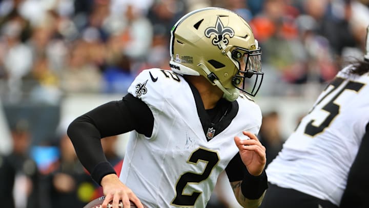 Oct 19, 2025; Chicago, Illinois, USA; New Orleans Saints quarterback Spencer Rattler (2) rushes the ball against the Chicago Bears during the second half at Soldier Field. Mandatory Credit: Mike Dinovo-Imagn Images