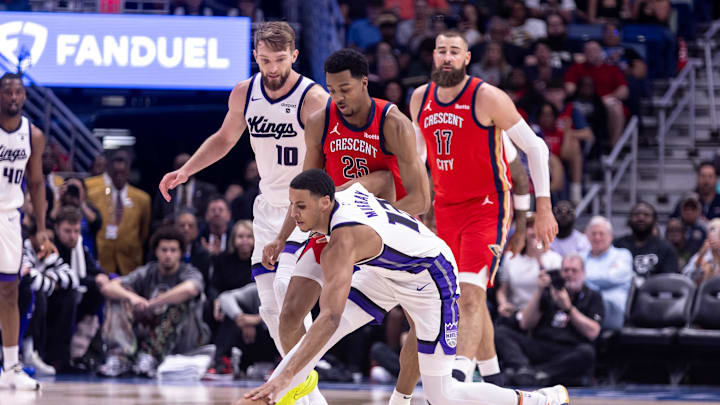 Apr 19, 2024; New Orleans, Louisiana, USA;  Sacramento Kings forward Keegan Murray (13) reaches for a loose ball against New Orleans Pelicans guard Trey Murphy III (25) in the first half during a play-in game of the 2024 NBA playoffs at Smoothie King Center. Mandatory Credit: Stephen Lew-Imagn Images