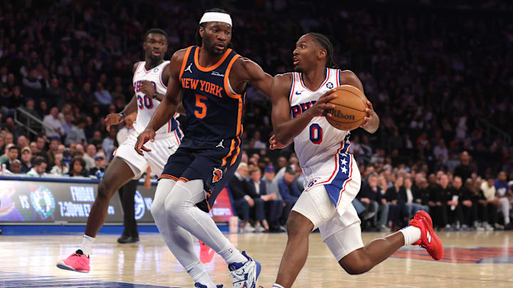 Feb 26, 2025; New York, New York, USA; Philadelphia 76ers guard Tyrese Maxey (0) drives to the basket against New York Knicks forward Precious Achiuwa (5) during the third quarter at Madison Square Garden. Mandatory Credit: Brad Penner-Imagn Images