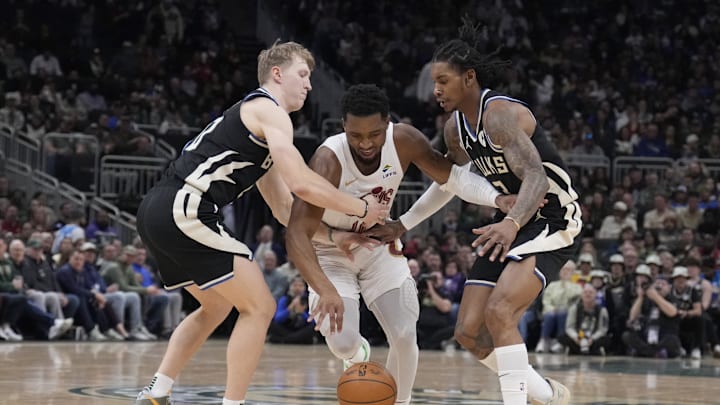 Mar 9, 2025; Milwaukee, Wisconsin, USA; Cleveland Cavaliers guard Donovan Mitchell (45) dribbles between Milwaukee Bucks guard AJ Green (20) and Milwaukee Bucks guard Kevin Porter Jr. (3) in the first half at Fiserv Forum. Mandatory Credit: Michael McLoone-Imagn Images Mar 9, 2025; Milwaukee, Wisconsin, USA; Cleveland Cavaliers guard Donovan Mitchell (45) dribbles between Milwaukee Bucks guard AJ Green (20) and Milwaukee Bucks guard Kevin Porter Jr. (3) in the first half at Fiserv Forum. Mandatory Credit: Michael McLoone-Imagn Images
