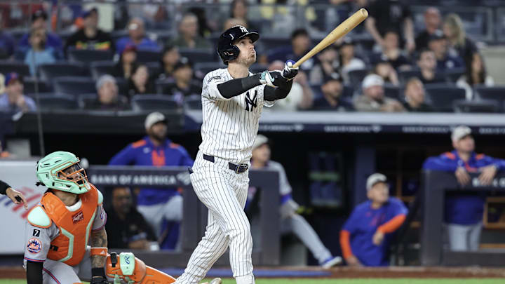 New York Yankees left fielder Cody Bellinger (35) hits a grand slam home run in the eighth inning against the New York Mets at Yankee Stadium. 