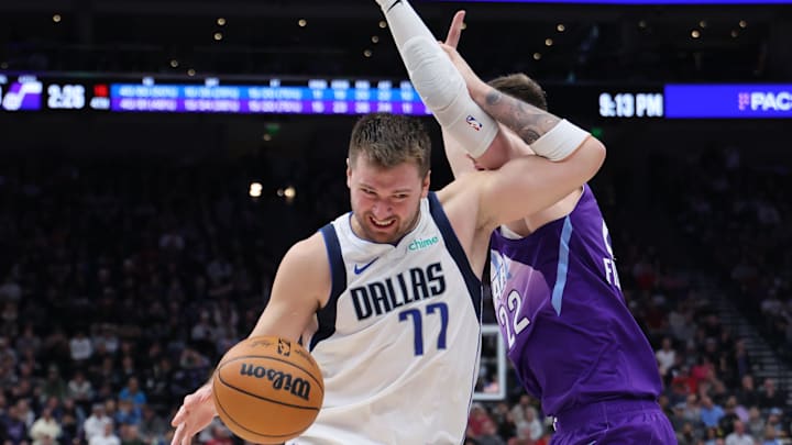 Nov 14, 2024; Salt Lake City, Utah, USA; Dallas Mavericks guard Luka Doncic (77) drives against Utah Jazz forward Kyle Filipowski (22) during the fourth quarter at Delta Center. Mandatory Credit: Rob Gray-Imagn Images