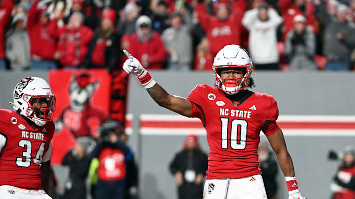 Nov 25, 2023; Raleigh, North Carolina, USA; North Carolina State Wolfpack receiver KC Concepcion (10) reacts after scoring a touchdown against the North Carolina Tar Heels during the first half at Carter-Finley Stadium. Mandatory Credit: Rob Kinnan-Imagn Images